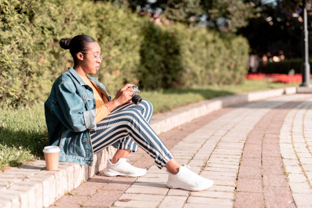 istock Young girl using digital camera in open air stock photo 1180428357