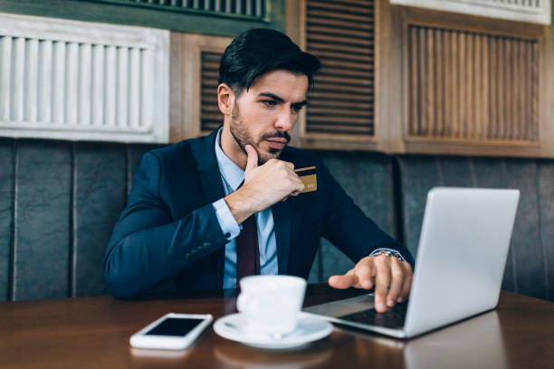 istock Businessman at coffee break shopping online 1180432450