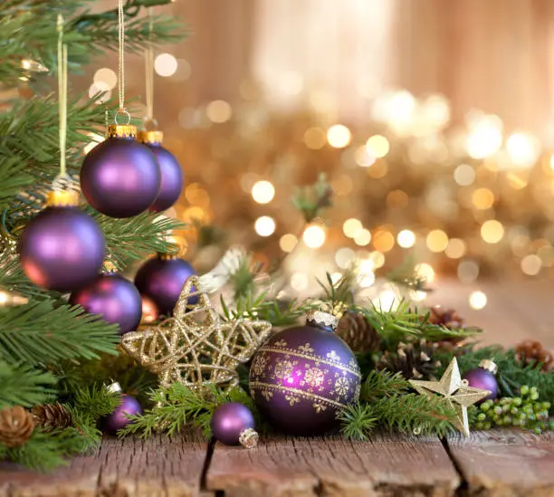 Photo of Christmas Purple Baubles and Gold Lights Background