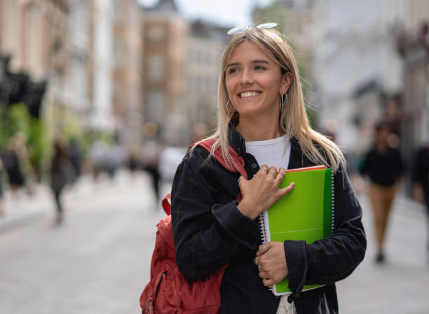 istock Happy female student walking outdoors in London 1180435372