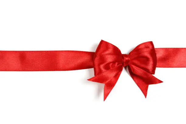 Photo of Shiny red satin ribbon on white background