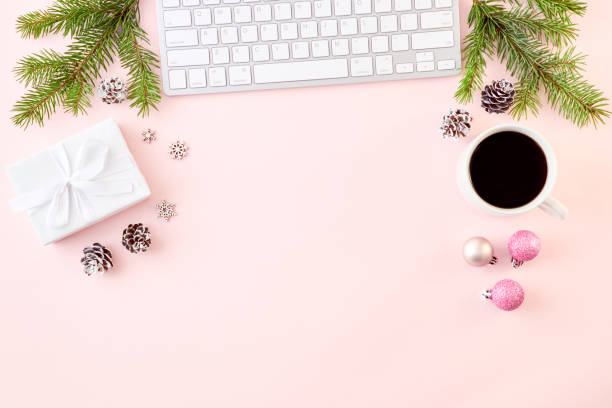 istock Flat lay christmas home office desk with spruce branches and keyboard, christmas decorations on a colored background 1180444703