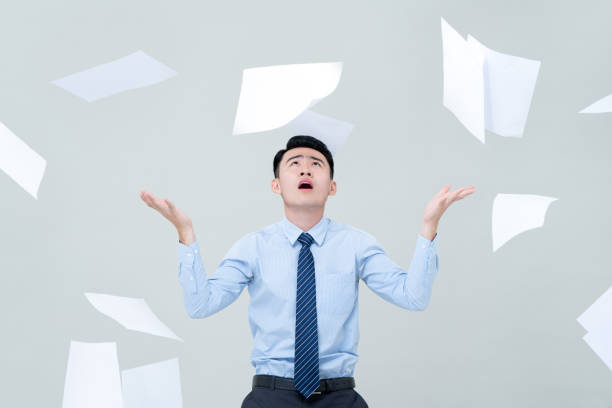 istock Busy Asian business man overwhelmed by too much work 1180445142