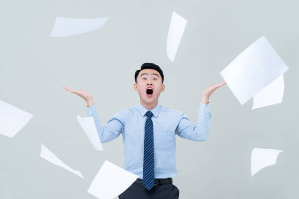 istock Busy Asian business man overwhelmed by too much work 1180445164