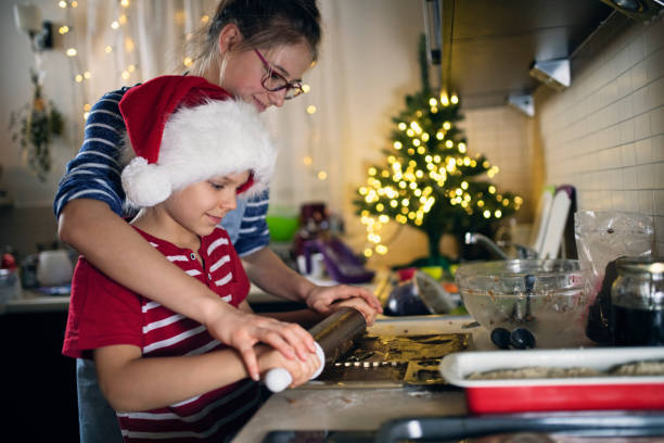 istock Brother and sister making gingerbread dough 1180445190