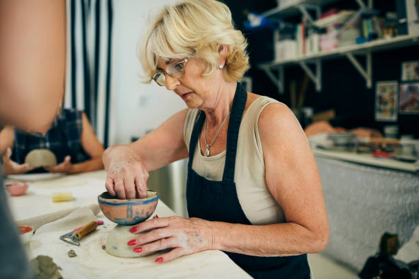 istock Senior Woman Make Ceramics Bowl At Ceramics Workshop 1180446458