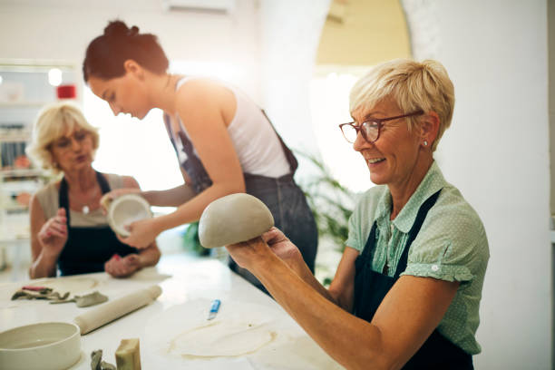 istock Senior Woman Modeling Clay At Ceramics Workshop 1180447142