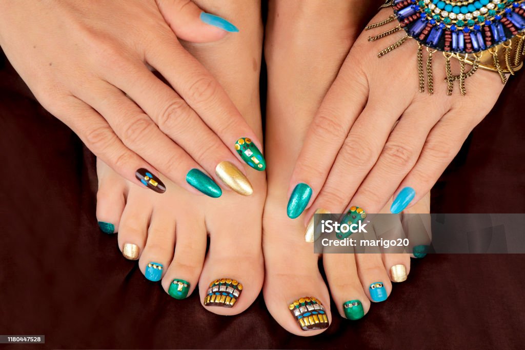 Multicolored Pedicure And Manicure With Rhinestones On Oval Long Female  Nails Stock Photo - Download Image Now - iStock