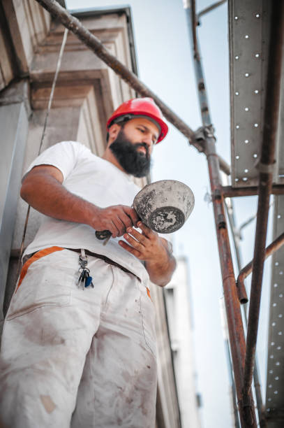 istock Construction mason worker mixing cement and sand with spatula 1180448306