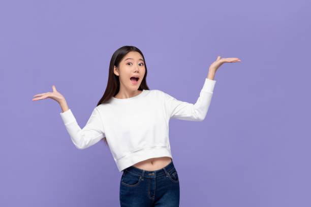 istock Excited Asian woman doing presenting gesture with both hands open 1180448470