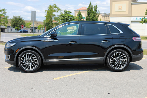 August 3, 2019 - Vaughan, Ontario, Canada: Brand new shiny Lincoln Nautilus 2019 Reserve model with premium 20 inch wheels in black color on an outdoor parking lot. Luxury SUV. Luxury car. North American Luxury SUV in Canada. Canadian made Linclon Nautilus 2019.