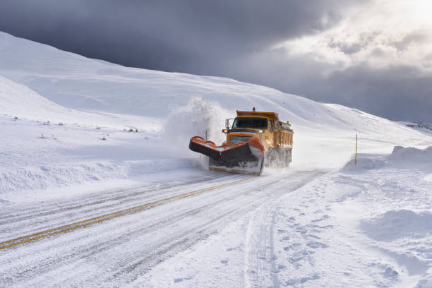 Yellow Snow Plow Clearing Snow in Wyoming stock photo