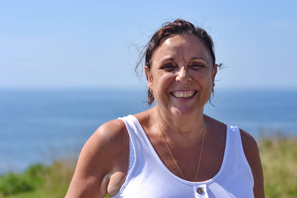 istock Mature woman by the sea side 1180461457