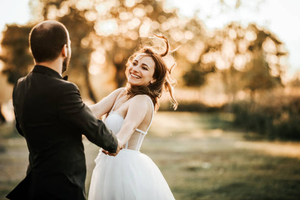 istock happy dancing couple at sunset 1180462198