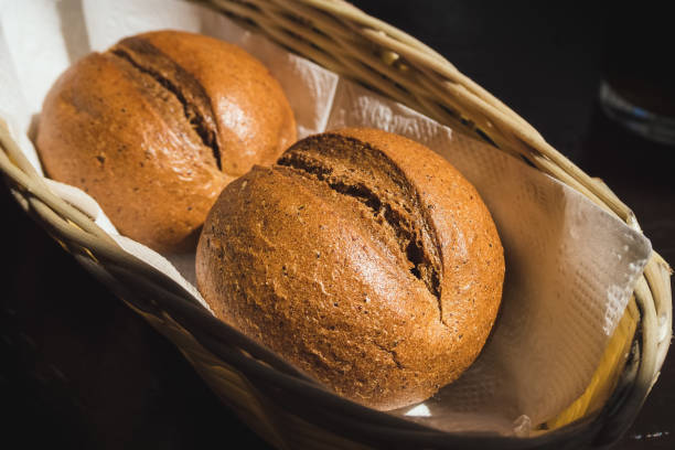 istock two rye round buns on a napkin in a straw basket close-up 1180462380