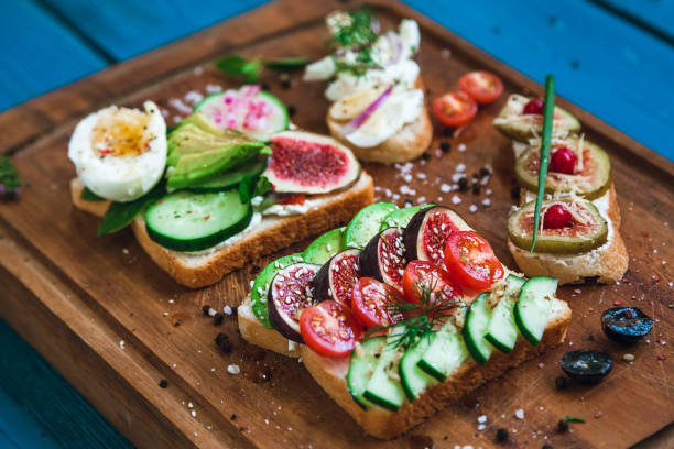 istock two sandwiches and two bruschettas on a wooden cutting board 1180463454