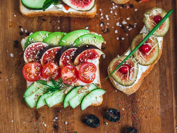 istock sandwich and two bruschetta on a wooden cutting board, top view 1180463469