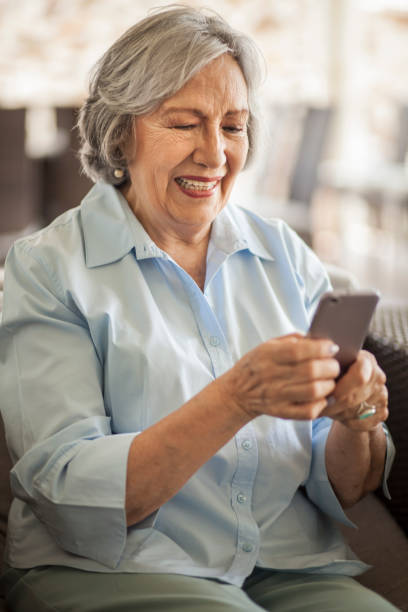 istock Senior woman speaking on smartphone, sitting 1180467489