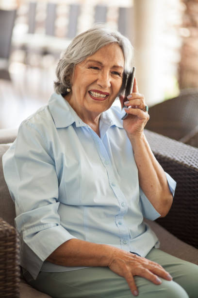 istock Senior woman speaking on smartphone, sitting 1180467580