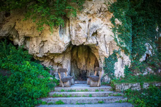 Photo of Benches and table in front of cave