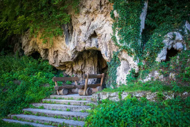 Photo of Benches and table in front of cave