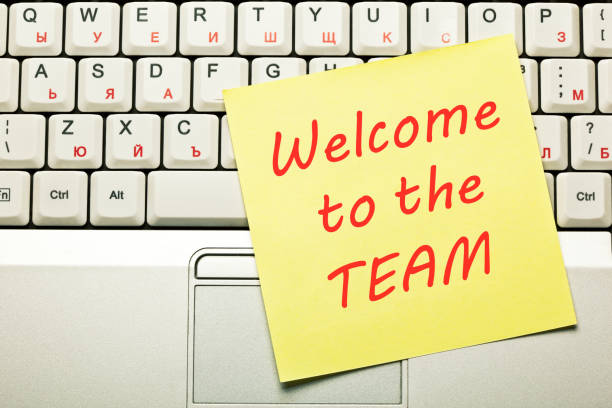 Welcome To The Team Concept Text Welcome to the Team handwritten on yellow sticky note on laptop keyboard. new hire stock pictures, royalty-free photos & images