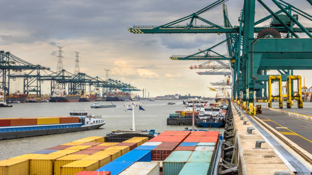 Busy port of Antwerp Loaded ships in busy port of Antwerp at container terminal with automated cranes and lots of vessels. Belgium commercial dock stock pictures, royalty-free photos & images