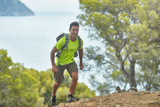 istock Smiling Mature Spanish Man Hiking Mediterranean Coast Trail 1180476529