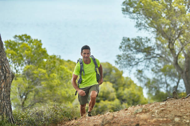 istock Mature Man Hiking Rugged Trail Along Mediterranean Coast 1180476531
