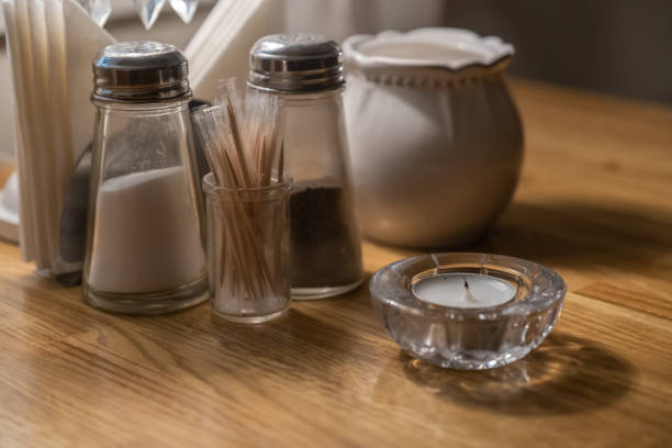 istock Salt shaker, pepper shaker, toothpicks and a candle on a table in a cafe 1180477047