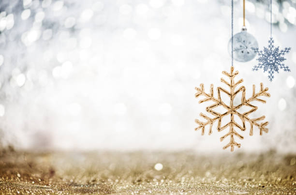 christmas ornaments against glittering defocused background - christmas gold christmas lights christmas ornament imagens e fotografias de stock