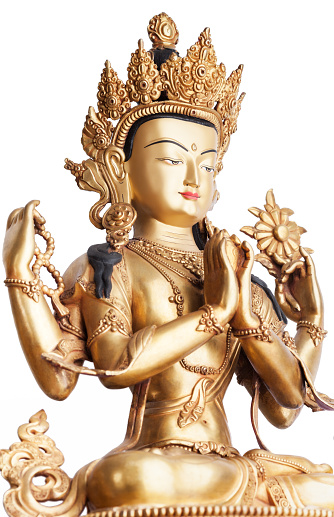 The gilded four-armed form of Avalokiteshvara made of metal isolated on white background. Executed in the Tibetan tradition.