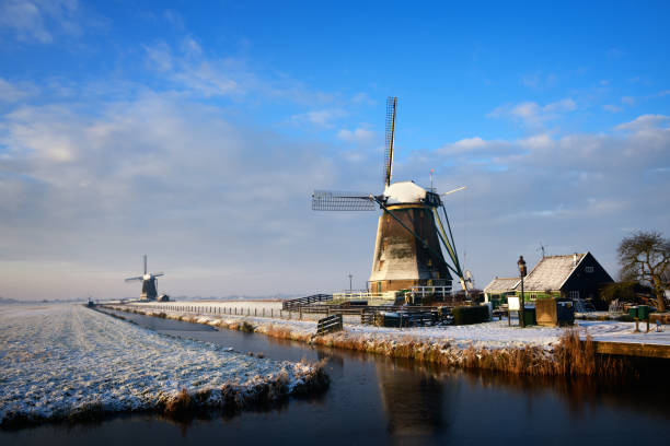 istock Windmill with a river under a layer of snow in a landscape in the Netherlands 1180478466