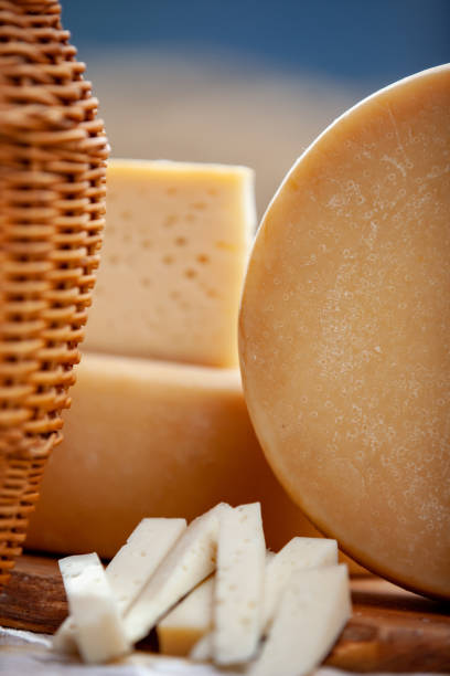 istock Whole cheese round on table with goat cheese serving slices 1180480342