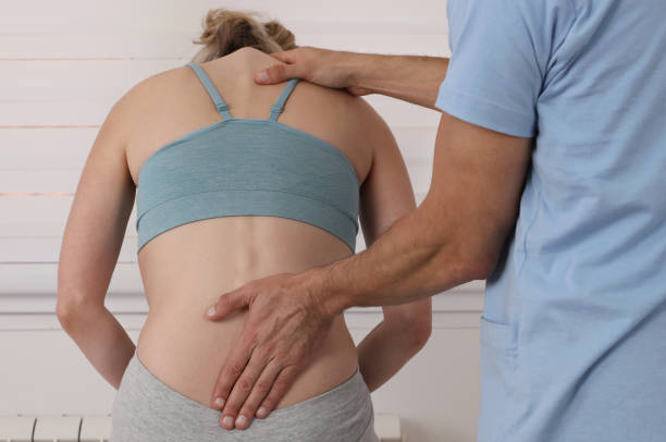 istock Scoliosis, Posture Correction. Chiropractic treatment, Back pain relief. Physiotherapy / Kinesiology for female patient 1180481341