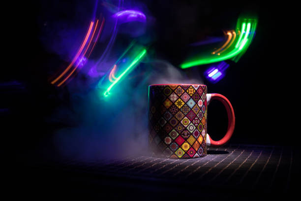 istock Beautiful eastern style textured ceramic cup of coffee (or tea) with smoke over dark toned background. 1180483404