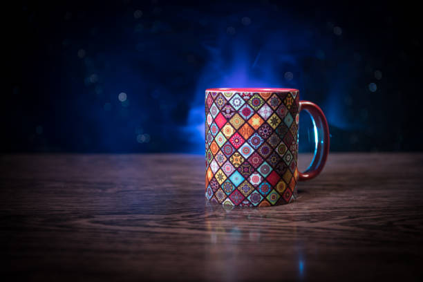 istock Beautiful eastern style textured ceramic cup of coffee (or tea) with smoke over dark toned background. 1180483406