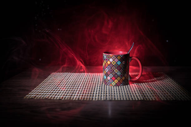 istock Beautiful eastern style textured ceramic cup of coffee (or tea) with smoke over dark toned background. 1180483410
