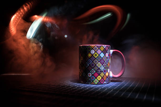 istock Beautiful eastern style textured ceramic cup of coffee (or tea) with smoke over dark toned background. 1180483411