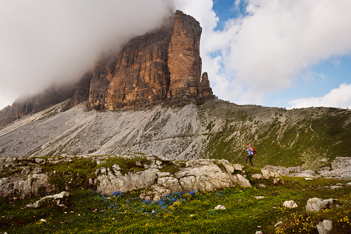 Hiker walk under the mountains Tre Cime di Lavaredo National Park, Dolomites, European Alps, Italy,Nikon D850