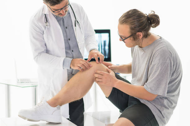 istock Full length of a young man getting his knee examined 1180484888