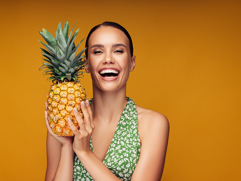 Beautiful girl with pineapple
