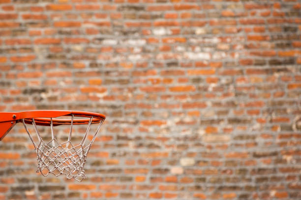 Basketball court by a brick wall background stock photo
