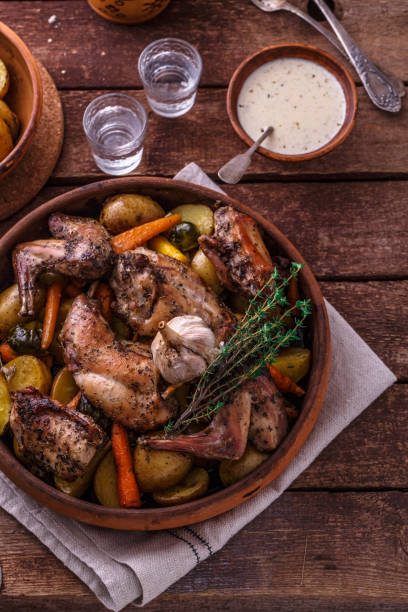 istock Rabbit with potatoes and carrots baked in a ceramic pot 1180485328