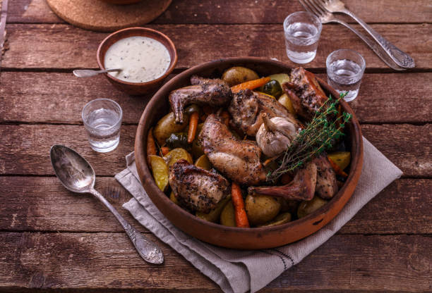 istock Rabbit baked with potatoe and herbs in a pot, copy space 1180485337