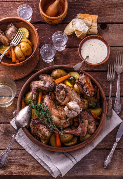 istock Oven baked rabbit with potato and carrots, top view 1180485338
