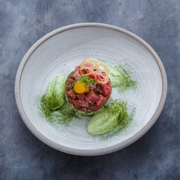 istock Fresh tuna tartar with lime, avocado sauce and yolk, restaurant dish 1180485423
