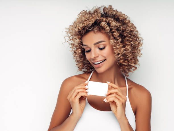 istock Beautiful woman with business card 1180487183