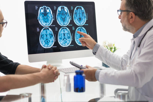 istock Male Doctor and Patient Examining brain MR 1180487320