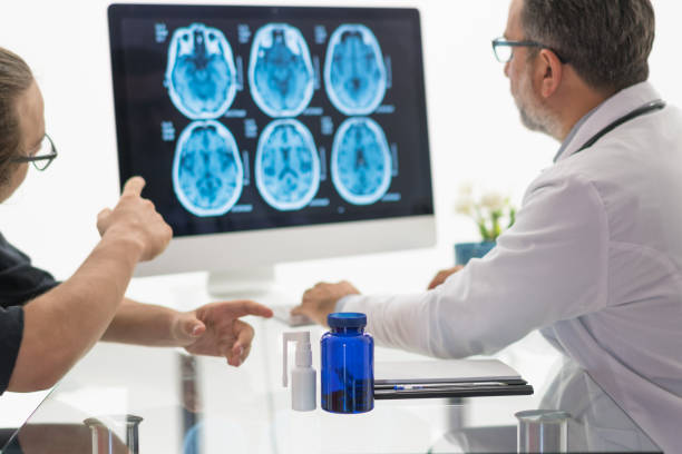 istock Male Doctor and Patient Examining brain MR 1180487420